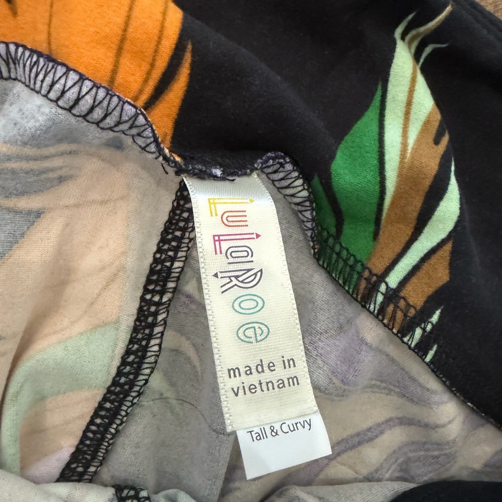 LuLaRoe Leggings in Black with Green, Yellow and Purple Feather Print - Picture 2 of 2